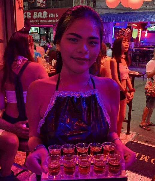 Thailand Prostitute Serving Drinks to Her Customers